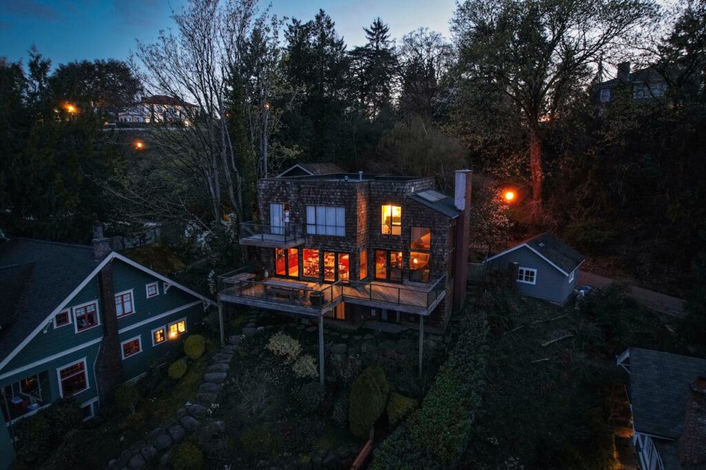 pexels photo 12995435 Aerial view of illuminated homes in Seattle's lush neighborhood at twilight.